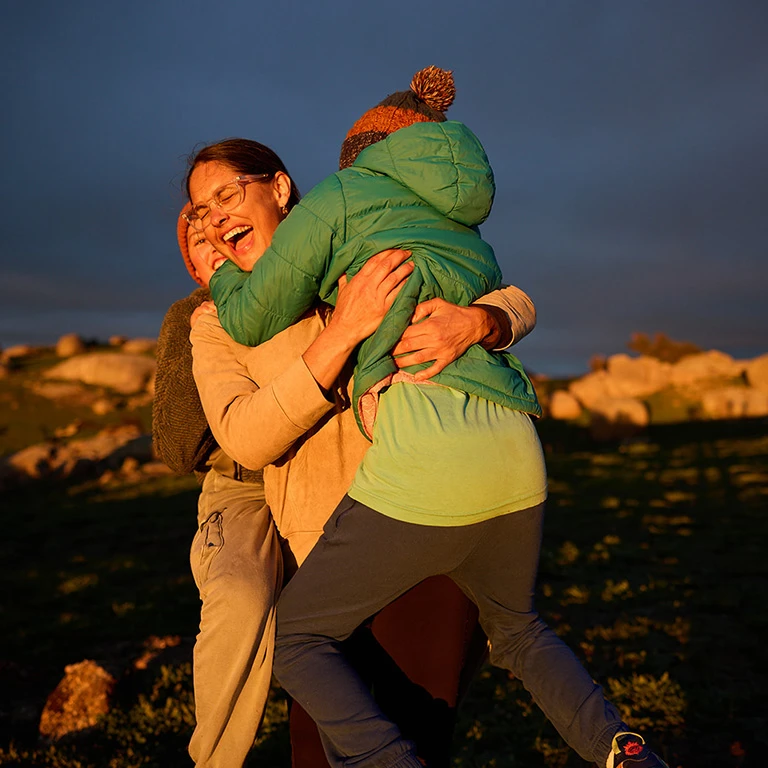 Family embrace at sunset