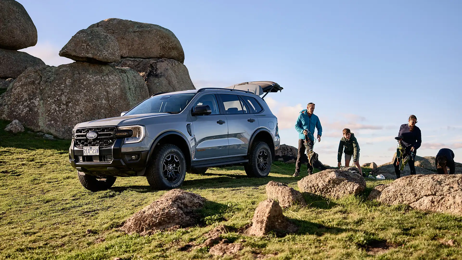 Family unloading grey Ford SUV