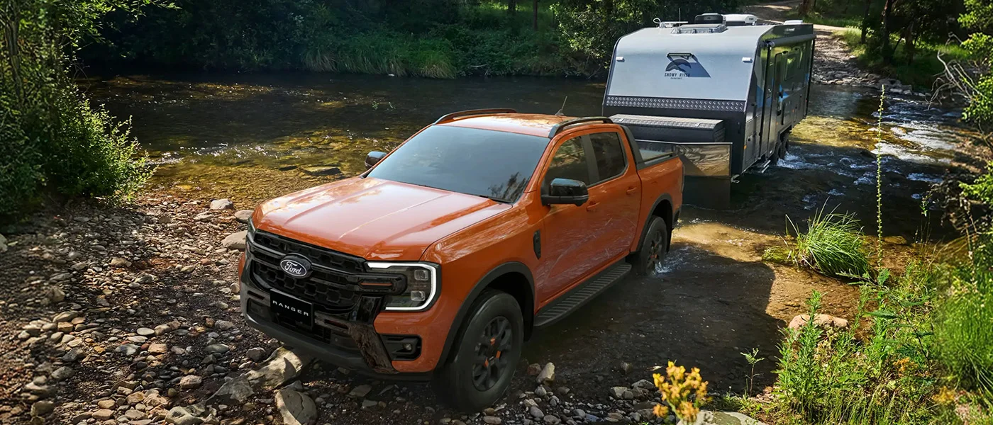 car with trailer on water
