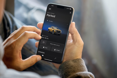 man with ford app in phone