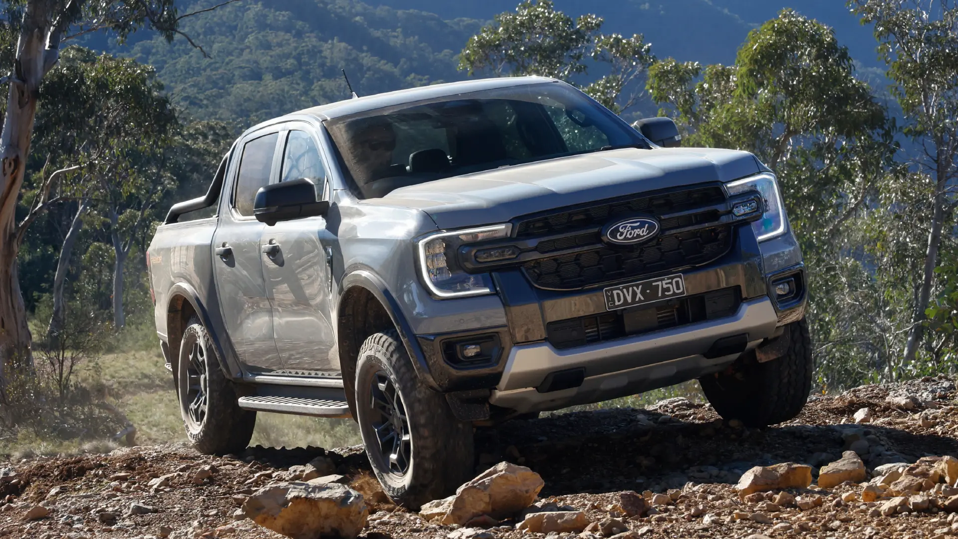 Silver pickup truck on rocky trail