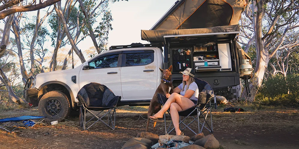 girl with a dog in front of a ford