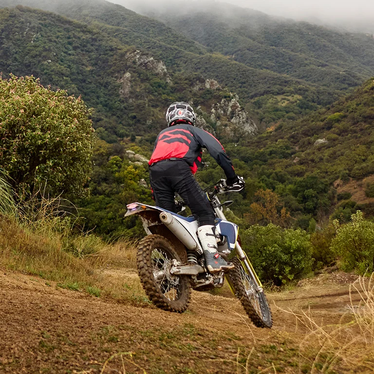 Dirt bike rider navigating a mountain trail