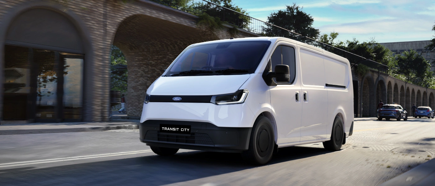White Ford van driving street.