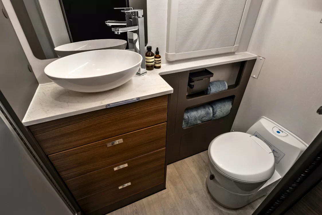 LDV Deliver 9 Motorhome ensuite bathroom featuring shower, toilet, vanity sink and wall-mounted washing machine