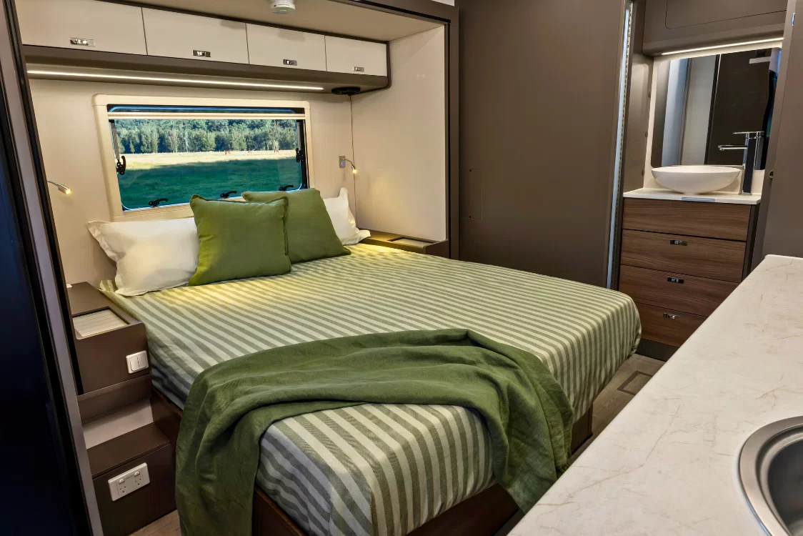 LDV Deliver 9 Motorhome master bedroom interior with comfortable double bed and warm timber cabinetry, sleeping up to four