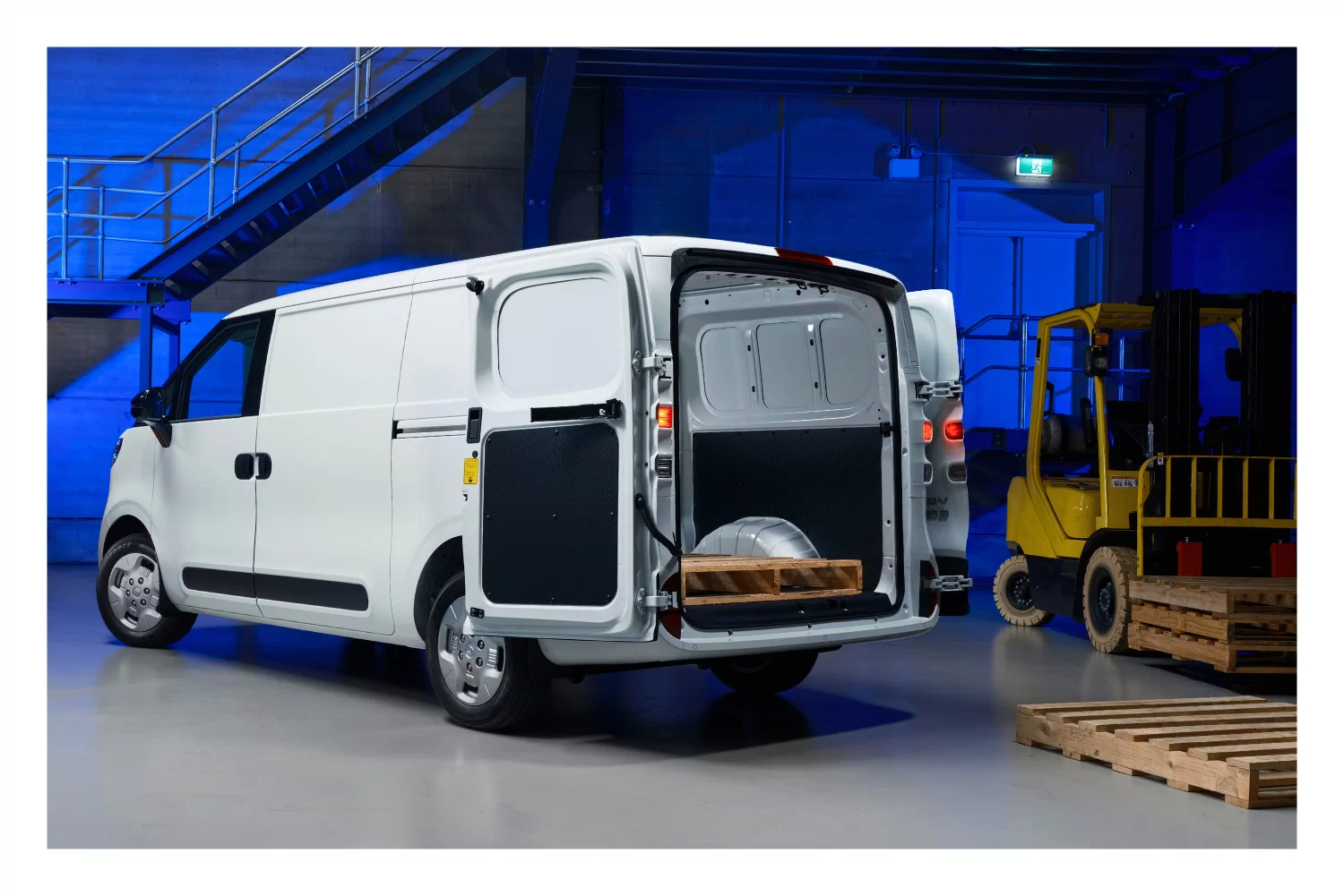 LDV eDeliver 5 electric van with rear barn doors open loading a wooden pallet in a warehouse