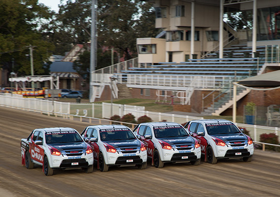 Team Isuzu D-MAX drive in formation on stadium track