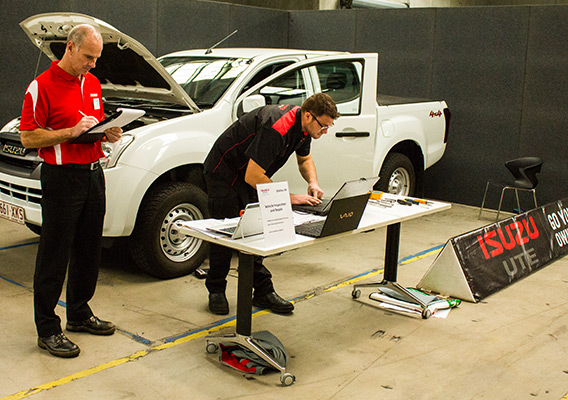 Contestant works on laptop connected to Isuzu D-MAX