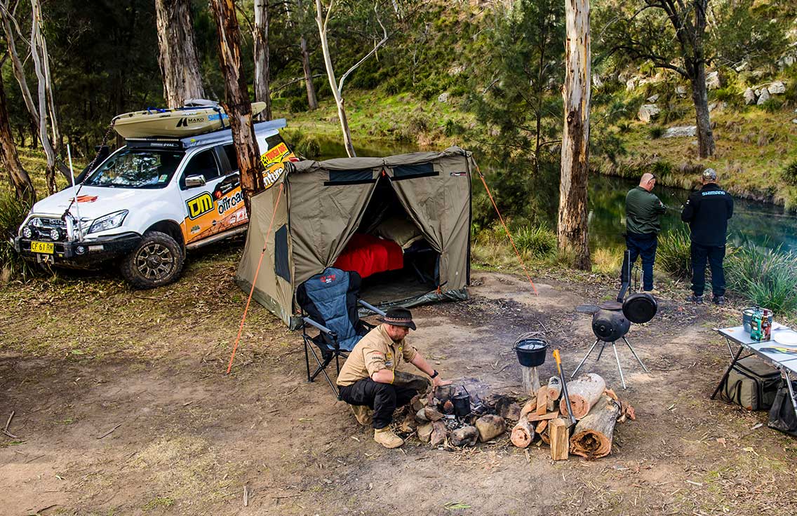 The 'Off-Road Adventure' team setting up camp next to river