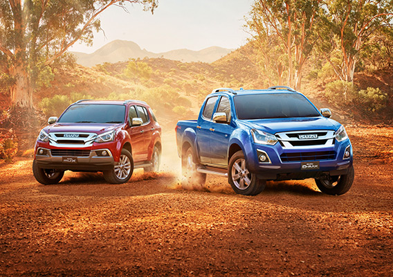 A Magnetic Red MU-X and a Cobalt Blue D-MAX diverge on outback gravel road