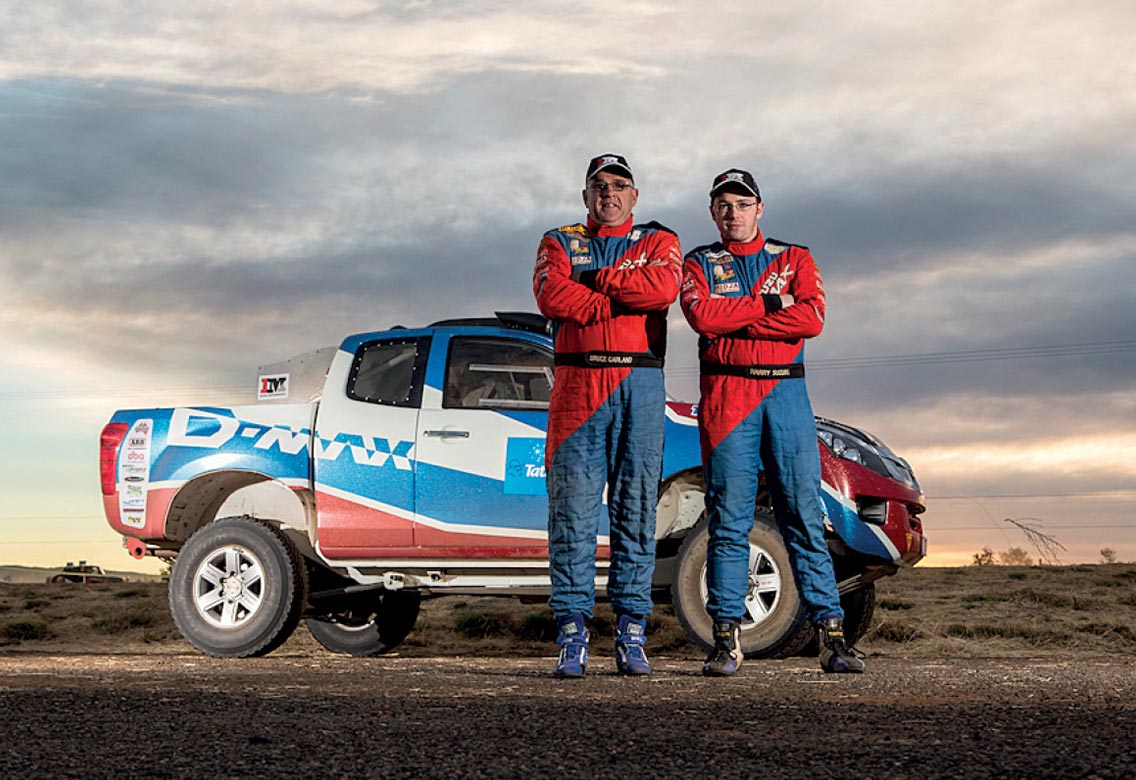 Bruce Garland and novice navigator Dylan Campbell pose next to the D-MAX in desert