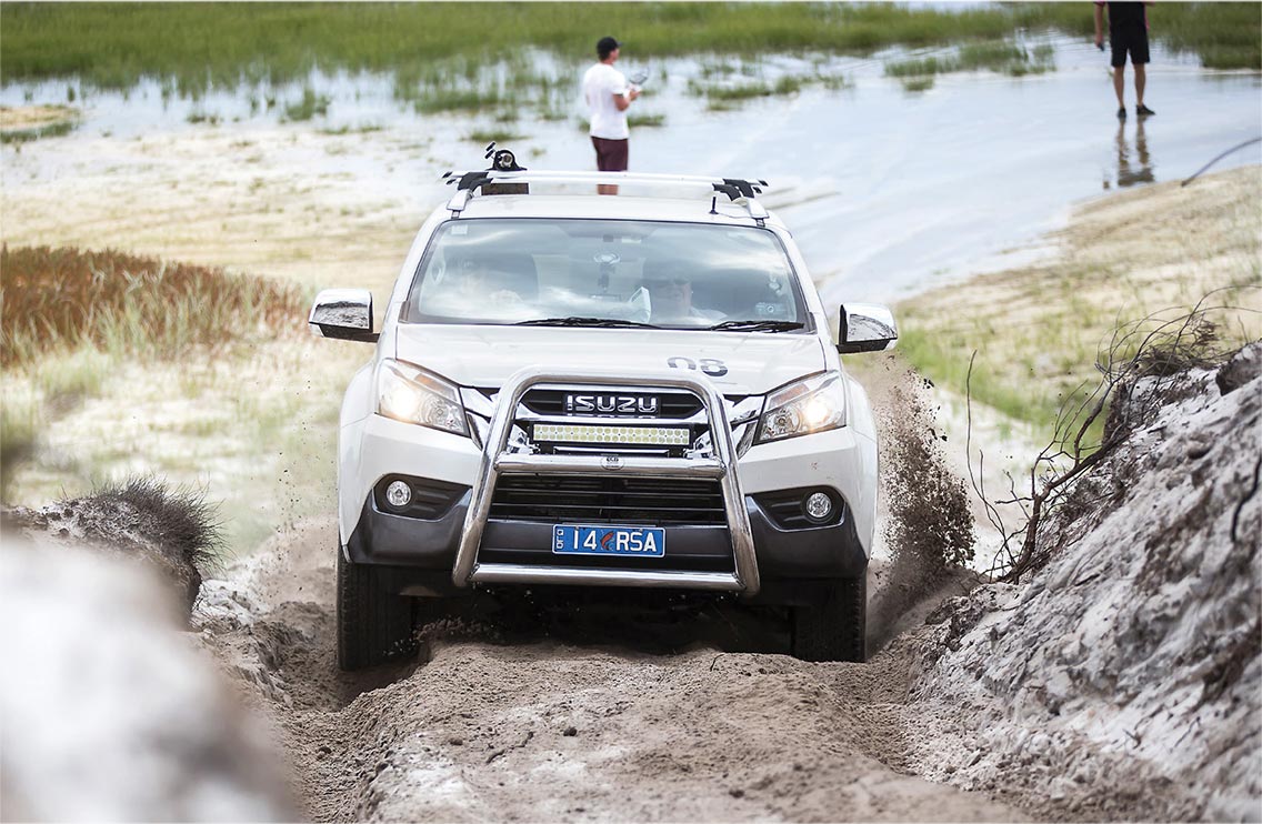 Isuzu MU-X drives up steep sand hill