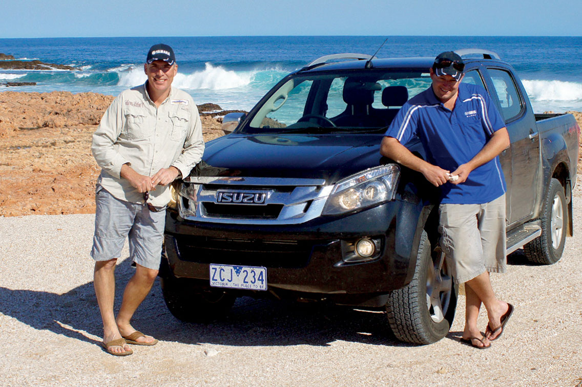Nick Duigan and Andrew Hart lean against their D-MAX next to the ocean