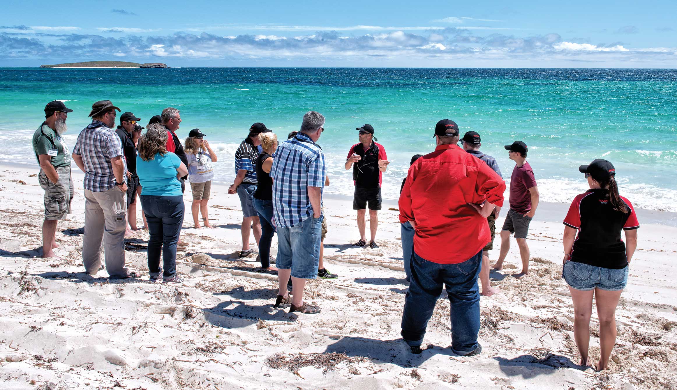 I-Venture Club participants listen to instructor on beach