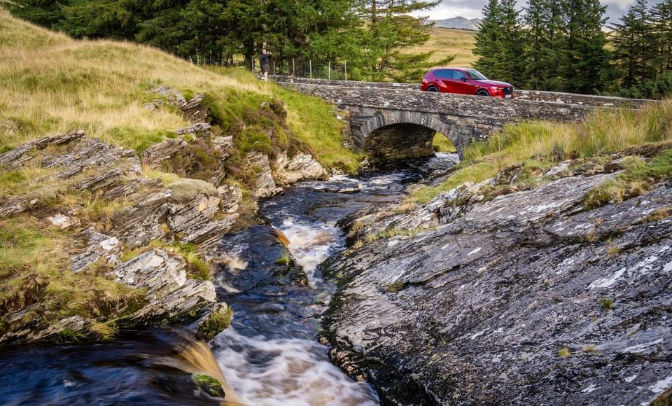 SUV CX-60 driving over bridge