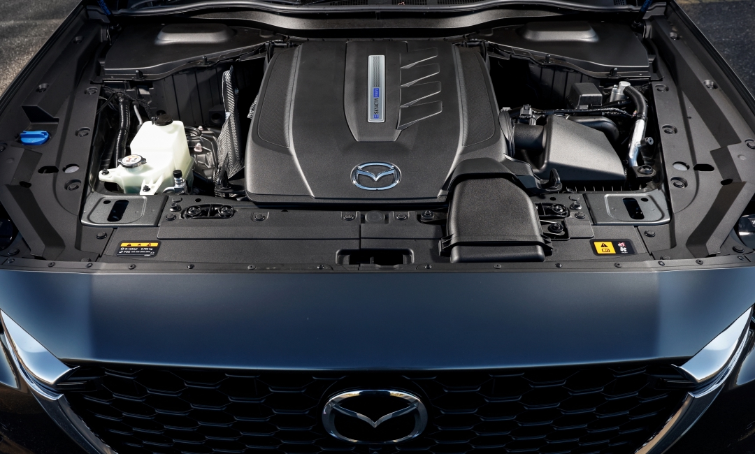 Close-up of Mazda CX-60 front with hood open, revealing the e-Skyactiv PHEV engine bay.