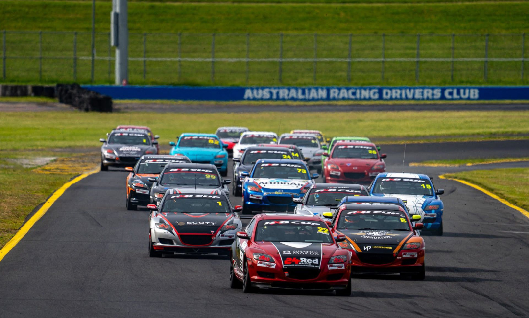 Mazda RX‑8 Cup field battling for position at an Australian motorsport event.