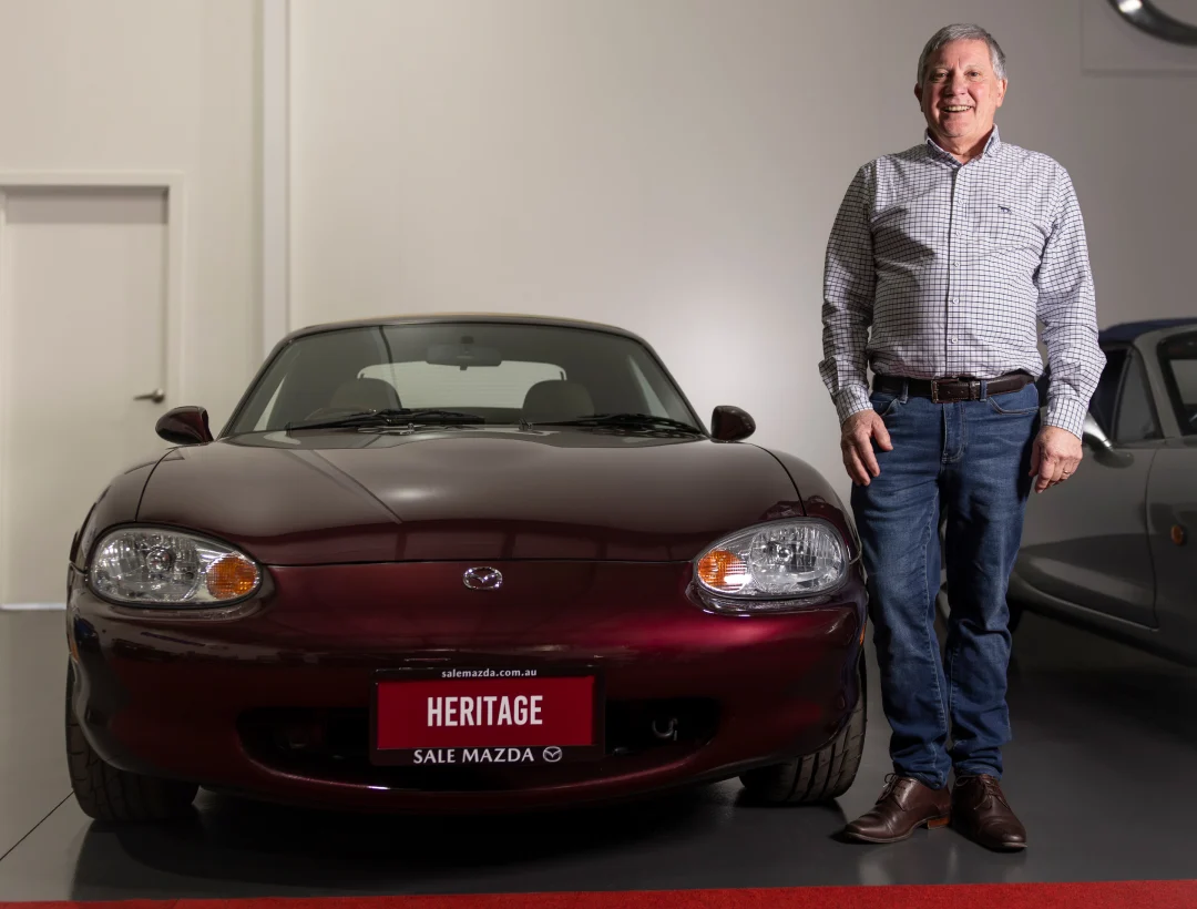 Mazda MX-5 Heritage Edition in Deep Art Vin Red Mica displayed indoors with Alan Wilson standing beside the car, part of Australia’s greatest MX-5 collection.
