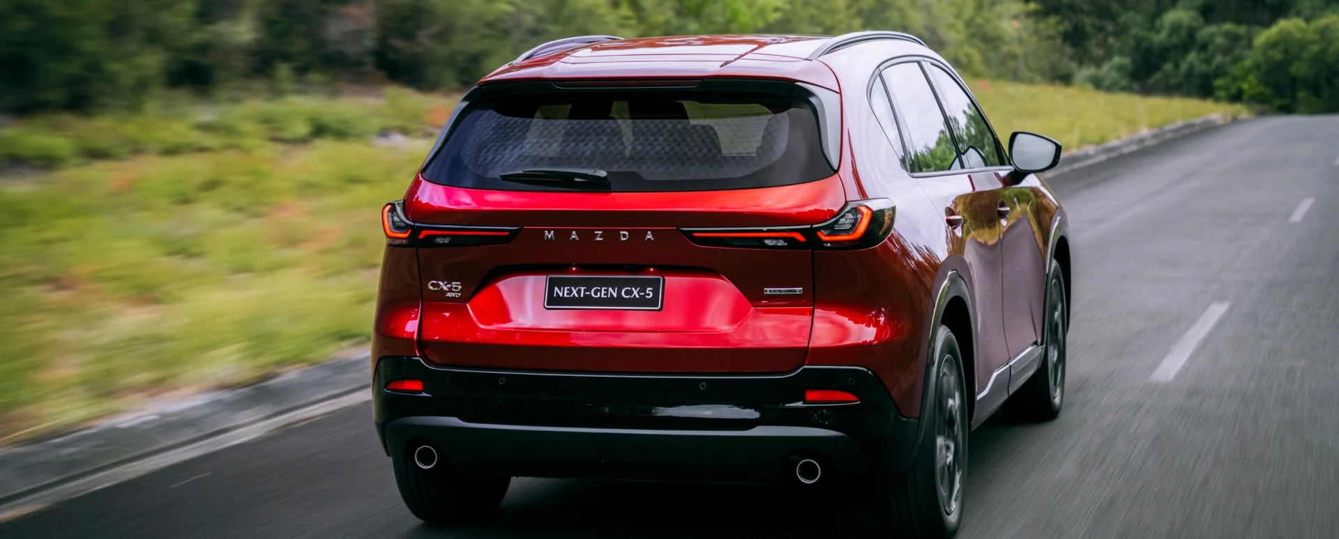 Rear of the Next-Gen Mazda CX-5 driving along the road